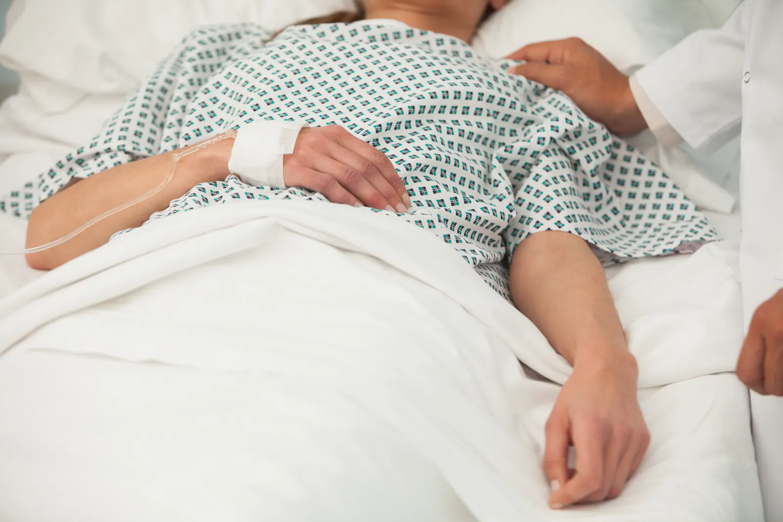 Injured patient recovering in a Sarasota hospital bed after being hit by a company vehicle